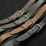 Collection of stylish leather belts showcasing different colors and textures.
