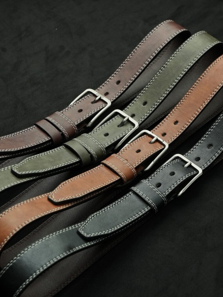 Collection of stylish leather belts showcasing different colors and textures.
