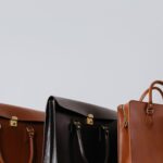A close-up view of three elegant leather briefcases emphasizing luxury and fashion.